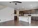 Spacious kitchen with stainless steel appliances, a kitchen island, and dark wood flooring at 9250 Rifle St, Commerce City, CO 80022
