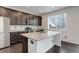 Modern kitchen features stainless steel appliances, granite countertops, and dark wood cabinets at 9250 Rifle St, Commerce City, CO 80022