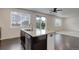 Kitchen with granite countertops, a stainless steel dishwasher, and a view of the living area at 9250 Rifle St, Commerce City, CO 80022
