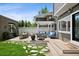 Inviting backyard featuring a stone patio, dining area, lush lawn, pergola, and outdoor seating, perfect for relaxation and entertaining at 758 N Franklin St, Denver, CO 80218