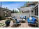 Charming backyard boasts a cozy seating area with plush blue cushions, ideal for enjoying outdoor living and entertaining guests at 758 N Franklin St, Denver, CO 80218