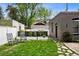 Serene backyard featuring lush greenery, stone pathways, and a seating area with rocking chairs for peaceful relaxation at 758 N Franklin St, Denver, CO 80218