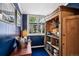Chic room with blue walls, storage cabinet and wet bar for drinks and serving at 758 N Franklin St, Denver, CO 80218