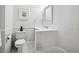Bright bathroom featuring white tiled walls, contemporary fixtures, and a framed beach scene at 758 N Franklin St, Denver, CO 80218