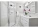 Modern bathroom featuring a glass shower enclosure, marble floors, and a double sink vanity at 758 N Franklin St, Denver, CO 80218