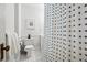 Clean bathroom featuring white tile, a blue polka dot shower curtain, and fresh towels at 758 N Franklin St, Denver, CO 80218