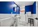 Stylish bathroom with cobalt blue walls, a pedestal sink, and a glass-enclosed shower at 758 N Franklin St, Denver, CO 80218