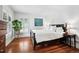 Bright bedroom featuring hardwood floors, a large window with shutters, and simple decor at 758 N Franklin St, Denver, CO 80218