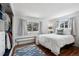 Well-lit bedroom with neutral tones, wooden floors, ample sunlight, and a cozy atmosphere at 758 N Franklin St, Denver, CO 80218