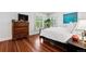 Bright bedroom with hardwood floors, white linens, and view of greenery through shuttered windows at 758 N Franklin St, Denver, CO 80218