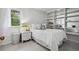 Cozy bedroom with white floors, a window with curtains, and a built-in bookshelf at 758 N Franklin St, Denver, CO 80218