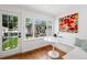 Bright breakfast nook featuring a built-in bench, hardwood floors, and a large window with garden view at 758 N Franklin St, Denver, CO 80218