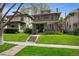 Attractive two-story home with a well-manicured lawn, stone steps, and classic architectural details, showcasing curb appeal at 758 N Franklin St, Denver, CO 80218