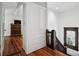 Hallway featuring hardwood floors, built-in storage, and staircase with dark wood accents at 758 N Franklin St, Denver, CO 80218