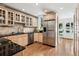 Modern kitchen with stainless steel appliances, granite countertops, and light wood cabinets at 758 N Franklin St, Denver, CO 80218