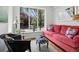 Cozy living room features a comfortable red sofa and natural light coming from a bright window at 758 N Franklin St, Denver, CO 80218