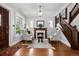 Bright living room featuring a fireplace, hardwood floors, staircase, and many windows at 758 N Franklin St, Denver, CO 80218