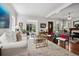 Bright and sunny living room with hardwood floors, white sofa and many decorative elements at 758 N Franklin St, Denver, CO 80218
