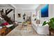 Bright living room with a white sofa, area rug, and staircase, creating a comfortable and airy atmosphere at 758 N Franklin St, Denver, CO 80218