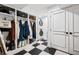 Mudroom area featuring built-in cubbies, coat racks, a stackable washer/dryer and checkered floors at 758 N Franklin St, Denver, CO 80218
