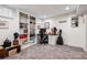Basement office with built-in shelving, desk and a guitar case against the wall at 758 N Franklin St, Denver, CO 80218