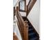 Elegant staircase with wood banister and blue carpet at 758 N Franklin St, Denver, CO 80218