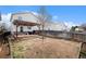 Large backyard with a stone patio, wooden pergola, and ample space for outdoor activities at 10700 Kimblewyck Cir # 225, Northglenn, CO 80233