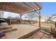 Spacious backyard featuring a stone patio and wooden pergola, perfect for outdoor entertaining at 10700 Kimblewyck Cir # 225, Northglenn, CO 80233