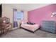 Childs bedroom with carpeted floors, pink walls and pastel furnishings at 10700 Kimblewyck Cir # 225, Northglenn, CO 80233