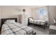 Spare bedroom with hardwood floors, dresser, and beds at 10700 Kimblewyck Cir # 225, Northglenn, CO 80233