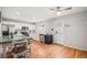 Bright kitchen features stainless steel appliances, a kitchen island with seating, and hardwood floors at 10700 Kimblewyck Cir # 225, Northglenn, CO 80233