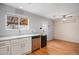 Modern kitchen with stainless steel appliances, bright white cabinets, and hardwood floors at 10700 Kimblewyck Cir # 225, Northglenn, CO 80233