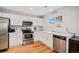 Bright kitchen with white cabinets, stainless steel appliances and ample countertop space at 10700 Kimblewyck Cir # 225, Northglenn, CO 80233