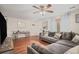 Cozy living room featuring hardwood floors, a comfortable sectional sofa, and a ceiling fan at 10700 Kimblewyck Cir # 225, Northglenn, CO 80233