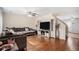 Spacious living room with hardwood floors, a large sectional sofa, fireplace, and television at 10700 Kimblewyck Cir # 225, Northglenn, CO 80233