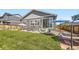 View of the backyard featuring a lawn, patio area, privacy fence and home's sliding doors at 6924 E 118Th Pl, Thornton, CO 80233