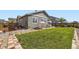 Backyard featuring a green lawn, patio area, and wooden fence for privacy at 6924 E 118Th Pl, Thornton, CO 80233
