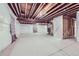 Spacious unfinished basement with exposed ceiling beams, concrete floor and a staircase at 6924 E 118Th Pl, Thornton, CO 80233