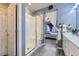 Bathroom and shower with glass door, vanity and access to the Primary bedroom at 6924 E 118Th Pl, Thornton, CO 80233