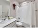 Bright bathroom showcasing a vanity with a sink, a toilet, and a shower with a curtain at 6924 E 118Th Pl, Thornton, CO 80233