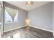 Bedroom boasts vinyl floors, ceiling fan, a large window, and neutral-colored walls at 6924 E 118Th Pl, Thornton, CO 80233