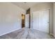 Neutral bedroom featuring gray carpet, gray walls, a double closet, and an open door at 6924 E 118Th Pl, Thornton, CO 80233