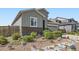 Charming home with grey siding, brick accents, and landscaping at 6924 E 118Th Pl, Thornton, CO 80233