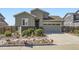 Attractive home featuring grey siding, brick accents, and a manicured lawn at 6924 E 118Th Pl, Thornton, CO 80233