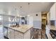Well-lit kitchen with a large island and modern appliances overlooking a living area at 6924 E 118Th Pl, Thornton, CO 80233