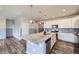 Open kitchen with sleek appliances, large island, and stylish cabinets at 6924 E 118Th Pl, Thornton, CO 80233