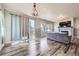 Bright living area featuring hardwood floors, large windows, and a cozy fireplace at 6924 E 118Th Pl, Thornton, CO 80233