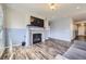 Spacious living room showcases a fireplace, TV, and wood floors, perfect for relaxing and entertaining at 6924 E 118Th Pl, Thornton, CO 80233