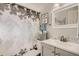 Bathroom with a decorative shower curtain, vanity, and a decorative butterfly on the mirror at 6069 S Marshall Dr, Littleton, CO 80123