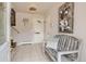 Inviting home entryway featuring neutral tones, tiled flooring, and a wooden bench at 6069 S Marshall Dr, Littleton, CO 80123